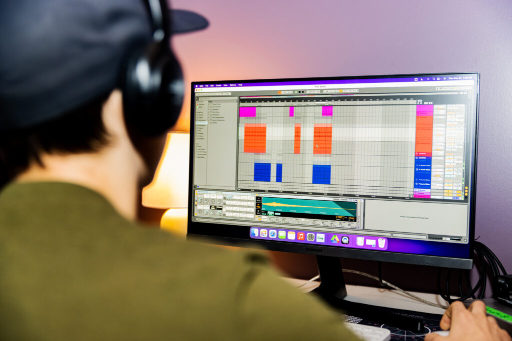 Student working on Ableton Live with headphones on